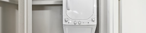 an empty laundry room with a washer and dryer